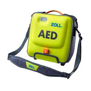 Grön defibrillator med ZOLL-märke, bärrem synlig.