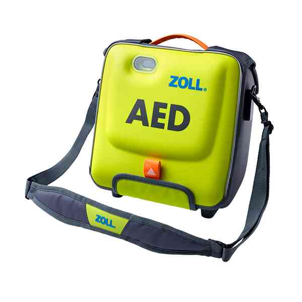 Grön defibrillator med ZOLL-märke, bärrem synlig.